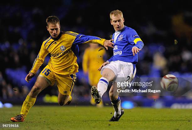 Tony Hibbert of Everton is challenged by Maksim Bordachov of BATE Borisov during the UEFA Europa League Group I match between Everton and BATE...