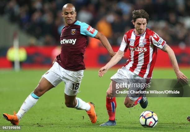 Joao Mario of West Ham and Joe Allen of Stoke battle for the ball during the Premier League match between West Ham United and Stoke City at London...