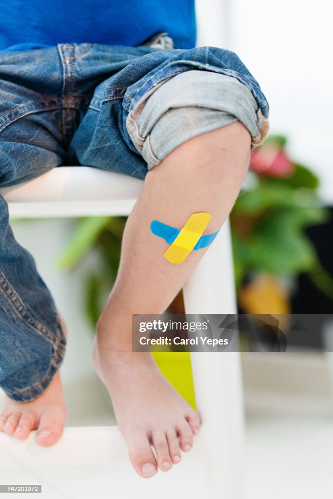 Child knee with an adhesive bandage