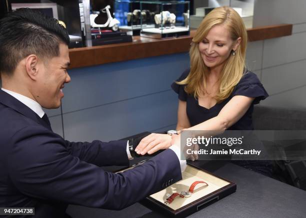 Jennifer Westfeldt tries on a watch at the IWC Tribeca Film Festival Filmmaker Award Celebration on April 16, 2018 in New York City.