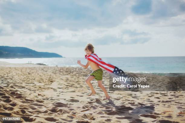 boy with usa flag summer towel running on beach - red white and blue beach stock pictures, royalty-free photos & images