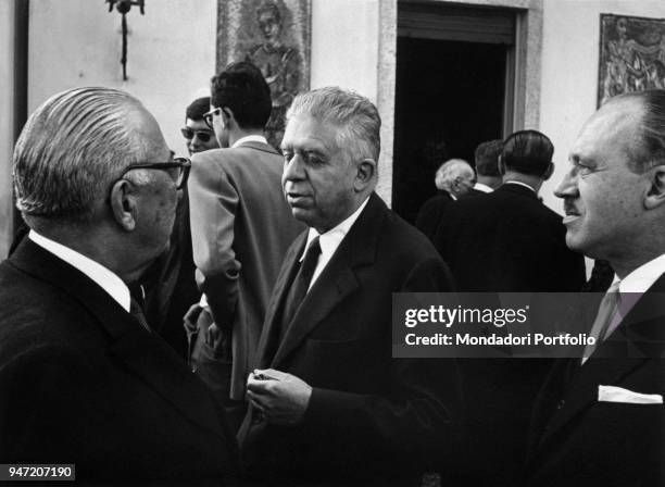 Italian publisher Arnoldo Mondadori celebrating his golden wedding with Italian poet Eugenio Montale and Italian writer Guido Piovene. Meina, October...
