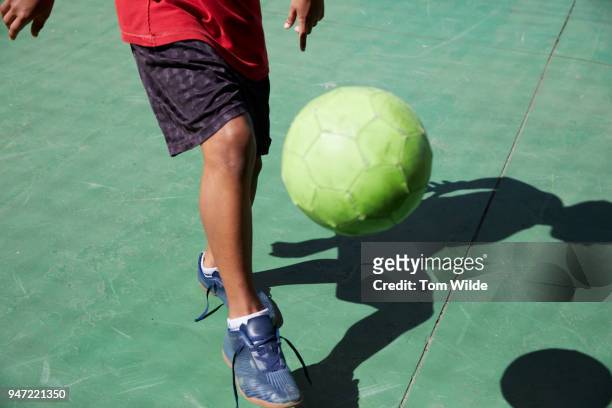 boy playing football - brazilian playing football stock pictures, royalty-free photos & images