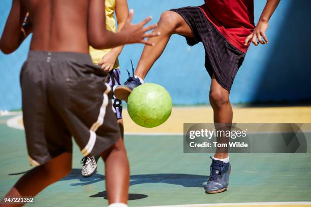 boys playing football/soccer - brazilian playing football stock-fotos und bilder