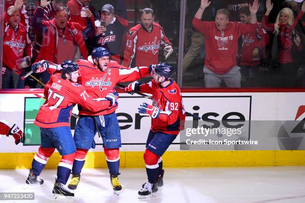 Washington Capitals left wing Alex Ovechkin is congratulated by right wing T.J. Oshie and center Evgeny Kuznetsov after scoring a second period goal...