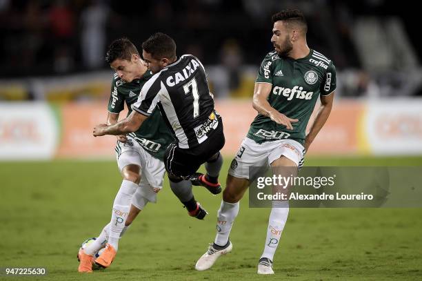 Leandro Carvalho of Botafogo struggles for the ball with Diogo Barbosa and Bruno Henrique of Palmeiras during the match between Botafogo and...