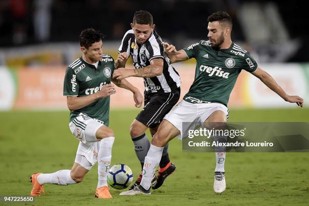 Leandro Carvalho of Botafogo struggles for the ball with Diogo Barbosa and Bruno Henrique of Palmeiras during the match between Botafogo and...