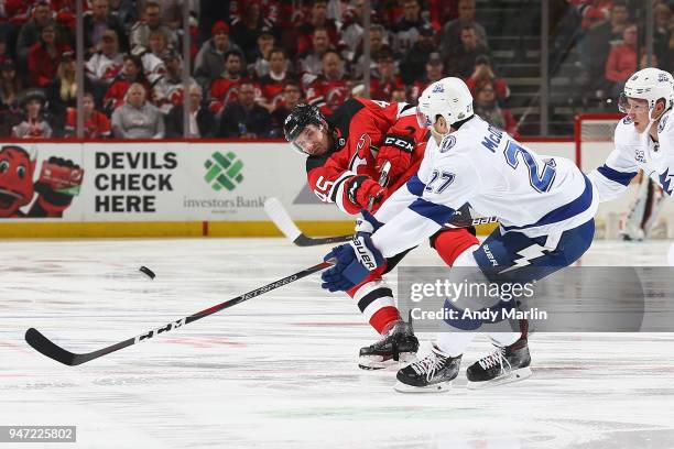 Ryan McDonagh of the Tampa Bay Lightning and Sami Vatanen of the New Jersy Devils battle for the puck in Game Three of the Eastern Conference First...