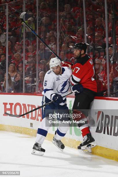 Dan Girardi of the Tampa Bay Lightning checks Patrick Maroon of the New Jersy Devils in Game Three of the Eastern Conference First Round during the...