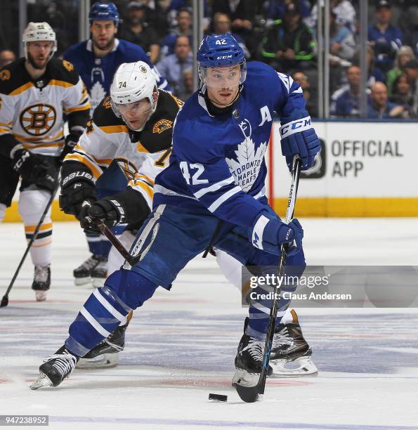 Jake DeBrusk of the Boston Bruins skates to check Tyler Bozak of the Toronto Maple Leafs in Game Three of the Eastern Conference First Round during...