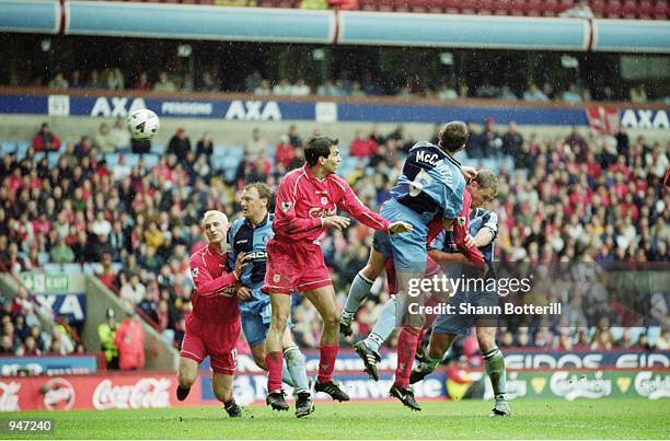 Paul McCarthy of Wycombe Wanderers is caught in between Markus Babbel and Stephane Henchoz of Liverpool during the AXA sponsored FA Cup Semi-Final...