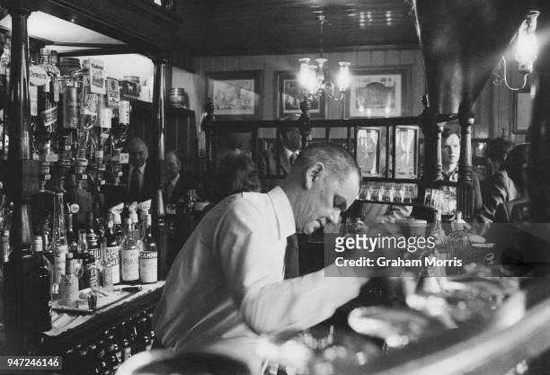 Bartender taps a a pint of beer at a Young's pub, The Lamb, in Bloomsbury, London, UK, 16th May 1977.