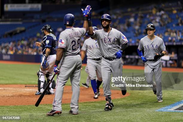 Nomar Mazara of the Texas Rangers is congratulated by Adrian Beltre after hitting a three run home run in the eighth inning during a game against the...