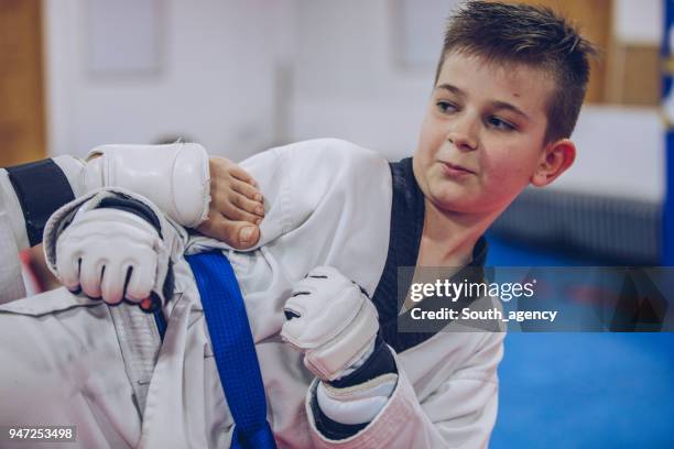 boy training taekwondo - karate belt stock pictures, royalty-free photos & images