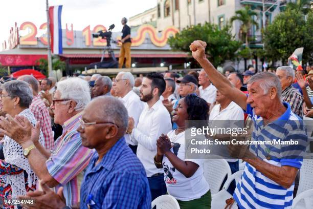 Cubans shout revolution slogans during a political act commemorating the 57th anniversary of a speech in which Fidel Castro declared the revolution...