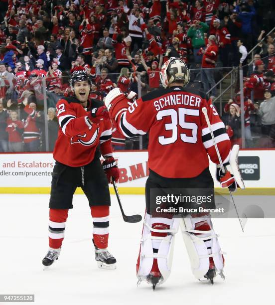 Ben Lovejoy of the New Jersey Devils celebrates his empty net goal at 19:22 of the third period against the Tampa Bay Lightning and is joined by Cory...