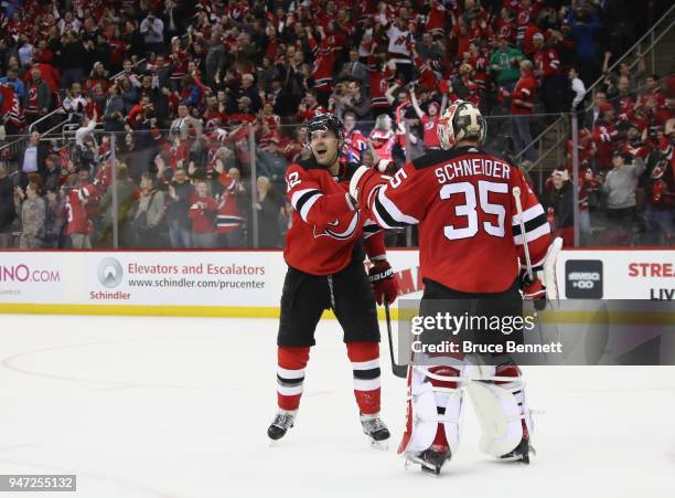 Ben Lovejoy of the New Jersey Devils celebrates his empty net goal at 19:22 of the third period against the Tampa Bay Lightning and is joined by Cory...