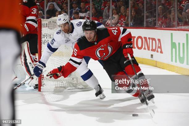 Sami Vatanen of the New Jersy Devils plays the puck against Braydon Coburn of the Tampa Bay Lightning in Game Three of the Eastern Conference First...