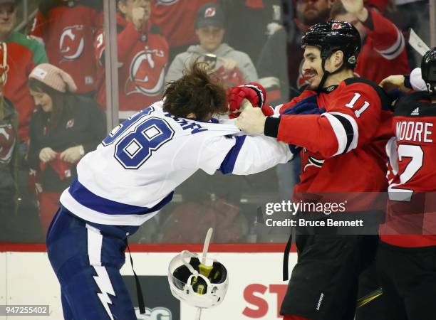 Mikhail Sergachev of the Tampa Bay Lightning fights with Brian Boyle of the New Jersey Devils during the third period in Game Three of the Eastern...
