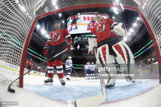 Ben Lovejoy and Cory Schneider of the New Jersey Devils react after a second period goal by Alex Killorn of the Tampa Bay Lightning in Game Three of...