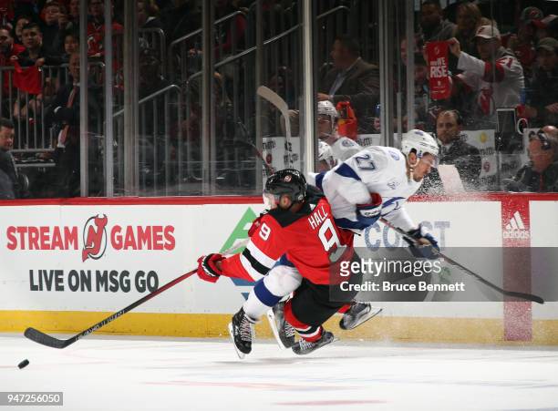 Ryan McDonagh of the Tampa Bay Lightning hits Taylor Hall of the New Jersey Devils during the third period in Game Three of the Eastern Conference...