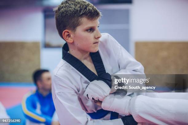 boy practicing taekwondo - karate belt stock pictures, royalty-free photos & images