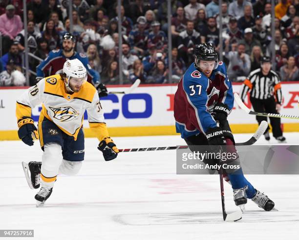 Colorado Avalanche left wing J.T. Compher skates the puck up ice against Nashville Predators right wing Ryan Hartman in the first period during the...