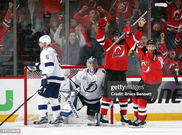 Patrick Maroon and Travis Zajac of the New Jersey Devils celebrate a powerplay goal by Will Butcher against the Tampa Bay Lightning at 4:04 of the...