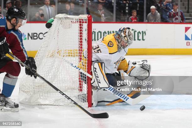 Goaltender Pekka Rinne of the Nashville Predators looks to gather the puck after a shot by Matt Nieto of the Colorado Avalanche in Game Three of the...