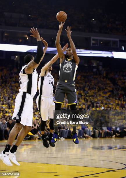 Kevin Durant of the Golden State Warriors shoots over Danny Green of the San Antonio Spurs during Game 2 of Round 1 of the 2018 NBA Playoffs at...