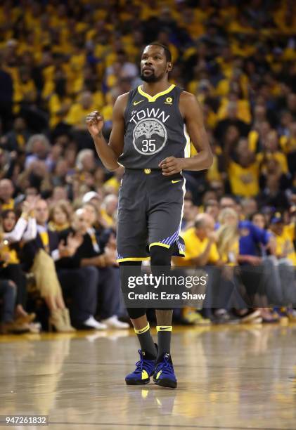 Kevin Durant of the Golden State Warriors reacts after Andre Iguodala of the Golden State Warriors made a basket against the San Antonio Spurs during...