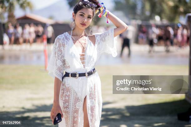 Guest wearing white sheer kimono is seen on April 14, 2018 in Indio, California.