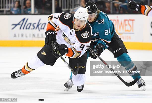 Hampus Lindholm of the Anaheim Ducks and Marcus Sorensen of the San Jose Sharks battle for control of the puck during the first period in Game Three...