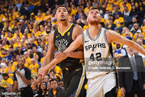 Davis Bertans of the San Antonio Spurs boxes out against Klay Thompson of the Golden State Warriors in Game Two of Round One of the 2018 NBA Playoffs...