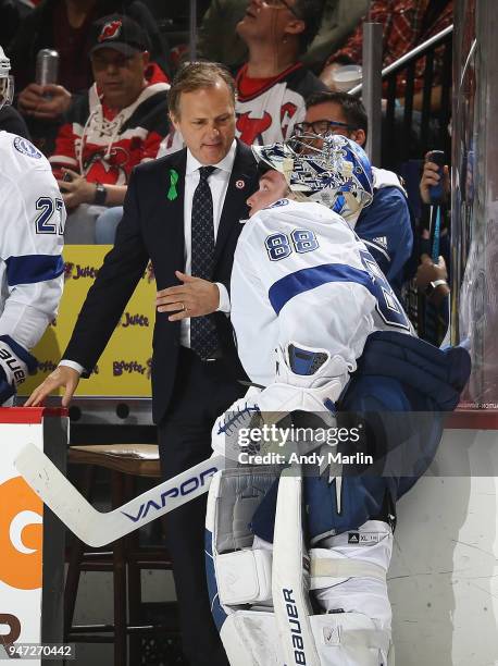 Andrei Vasilevskiy of the Tampa Bay Lightning talks with head coach Jon Cooper just prior to being taken out of the game for an extra skater late in...