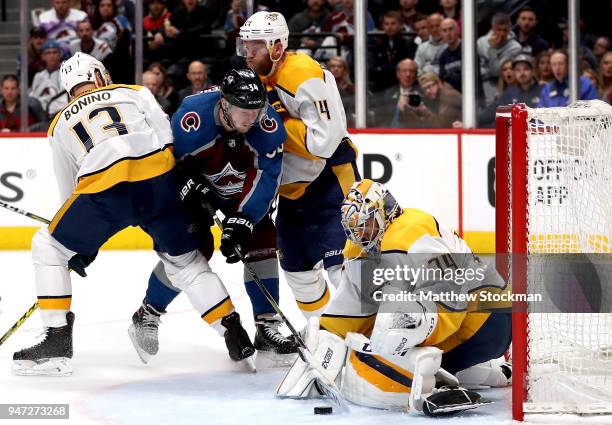 Carl Soderberg of the Colorado Rockies takes the puck to the goal against Nick Bonino, Mattias Ekholm and Juuse Saros of the Nashville Predators in...