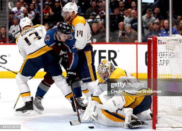 Carl Soderberg of the Colorado Rockies takes the puck to the goal against Nick Bonino, Mattias Ekholm and Juuse Saros of the Nashville Predators in...