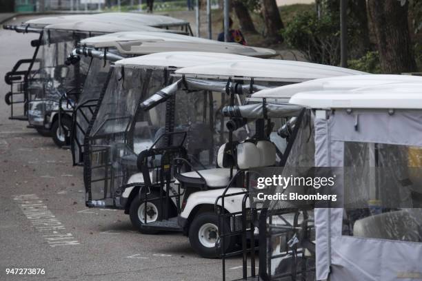 Golf carts stand parked in Discovery Bay, a residential project developed by Hong Kong Resort Co., on Lantau Island in Hong Kong, China, on Tuesday,...