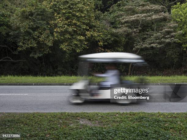 Golf cart travels along a road in Discovery Bay, a residential project developed by Hong Kong Resort Co., on Lantau Island in Hong Kong, China, on...