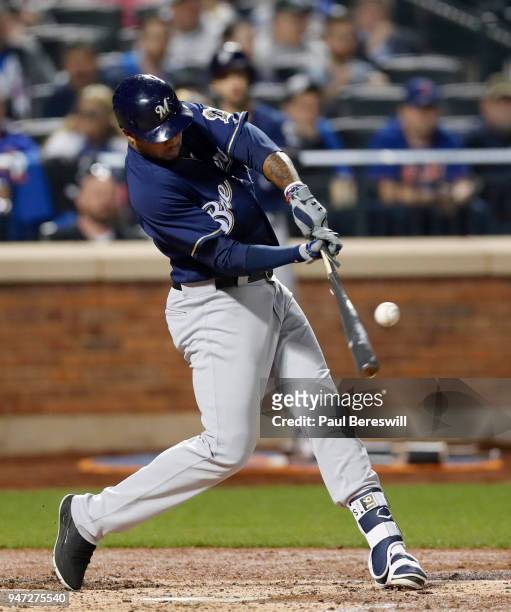Domingo Santana of the Milwaukee Brewers breaks his bat as he hits the ball in an MLB baseball game against the New York Mets on April 13, 2018 at...