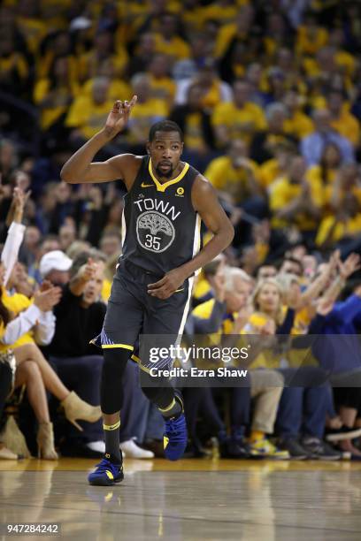 Kevin Durant of the Golden State Warriors reacts after he made a three-point basket against the San Antonio Spurs during Game 2 of Round 1 of the...