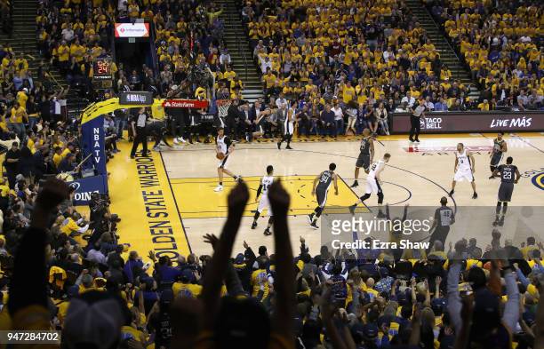 Fans react after Klay Thompson of the Golden State Warriors made a three-point basket against the San Antonio Spurs during Game 2 of Round 1 of the...