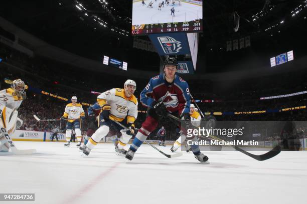 Mikko Rantanen of the Colorado Avalanche eyes the puck beside Alexei Emelin of the Nashville Predators in Game Three of the Western Conference First...