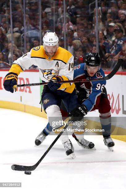 Mattias Ekholm of the Nashville Predators fights for control of the puck against Mikko Rantanen of the Colorado Rockies in Game Three of the Western...