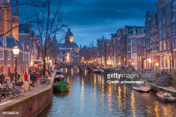 red light destrict view and amsterdam canal, bicycles and cyclists, houseboats, living boats. (ed) - amsterdam stock pictures, royalty-free photos & images
