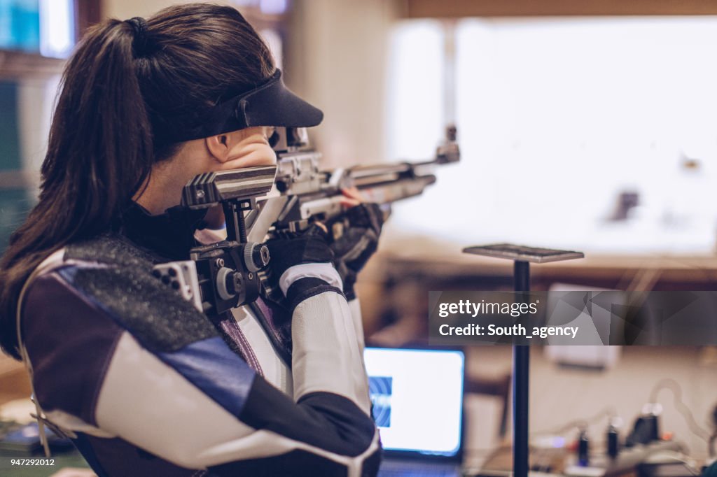 Woman on rifle shooting training