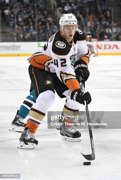 Josh Manson of the Anaheim Ducks skates up ice with control of the puck pursued by Evander Kane of the San Jose Sharks during the third period in...