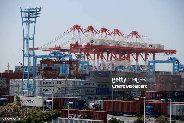 Containers and gantry cranes stand at a shipping terminal in Yokohama, Japan, on Monday, April 16, 2018. Japan and China held their first...