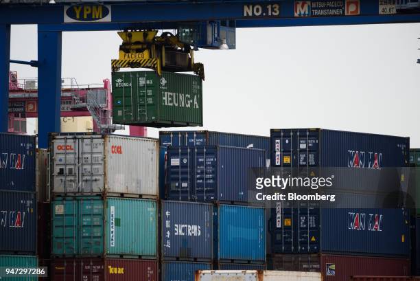 Gantry cranes transport containers at a shipping terminal in Yokohama, Japan, on Monday, April 16, 2018. Japan and China held their first...