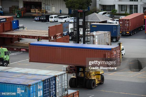 Straddle carrier transports a container at a shipping terminal in Yokohama, Japan, on Monday, April 16, 2018. Japan and China held their first...